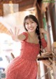 A woman in a red dress posing for a magazine.