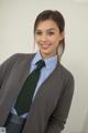 A woman in a school uniform posing for a picture.